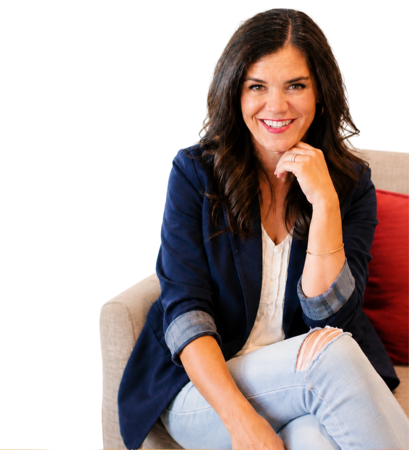 Bonnie Randle smiling, seated on a couch, chin resting on her hand